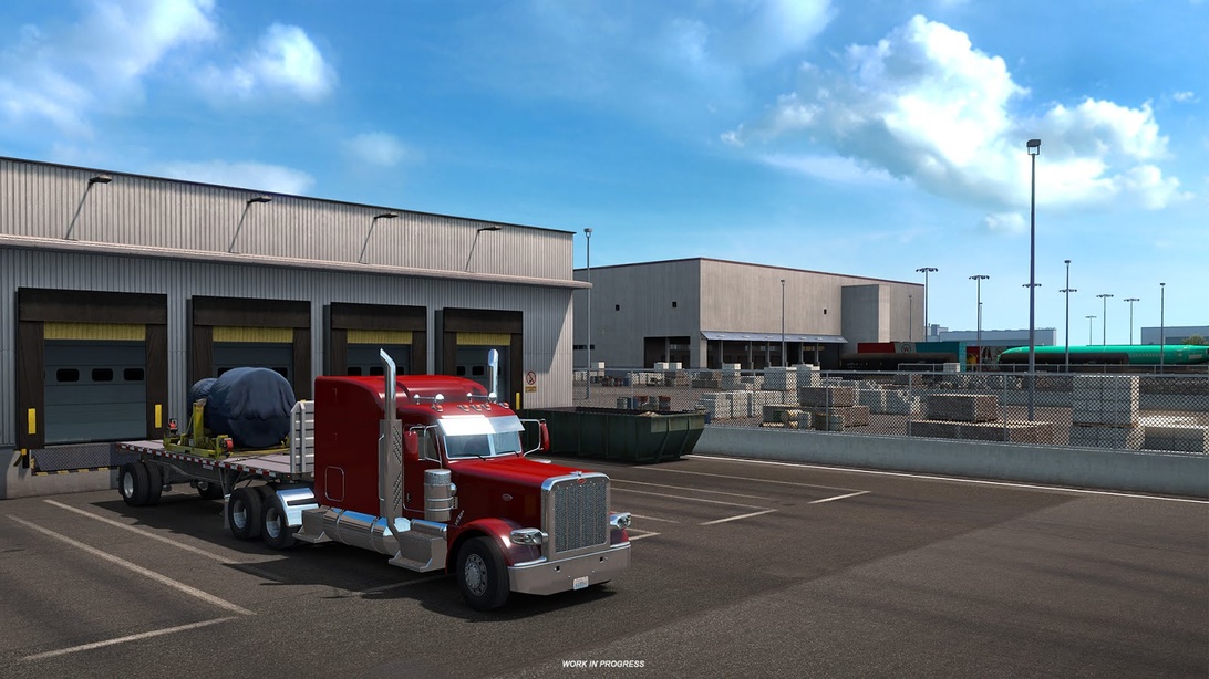 Eine Logistikanlage mit Laderampen und einem geparkten Lastwagen mit Tieflader. Das Industriegebäude dient als Versand- und Empfangszentrum für Flugzeugteile.